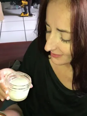 A brunette babe is licking a fucking jar of ‘cream,’ looking like she’s thirsting for a good load of cum.