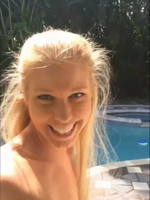 Blonde bombshell edging herself poolside – she drips, not the pool.